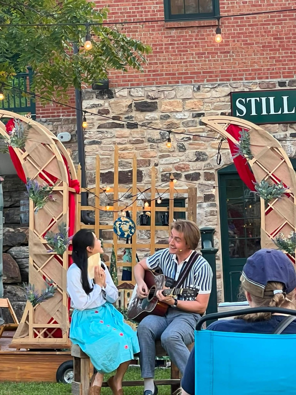 Tristan serenading a fellow actor outdoors during St. Louis Shakespeare Festival’s TourCo production